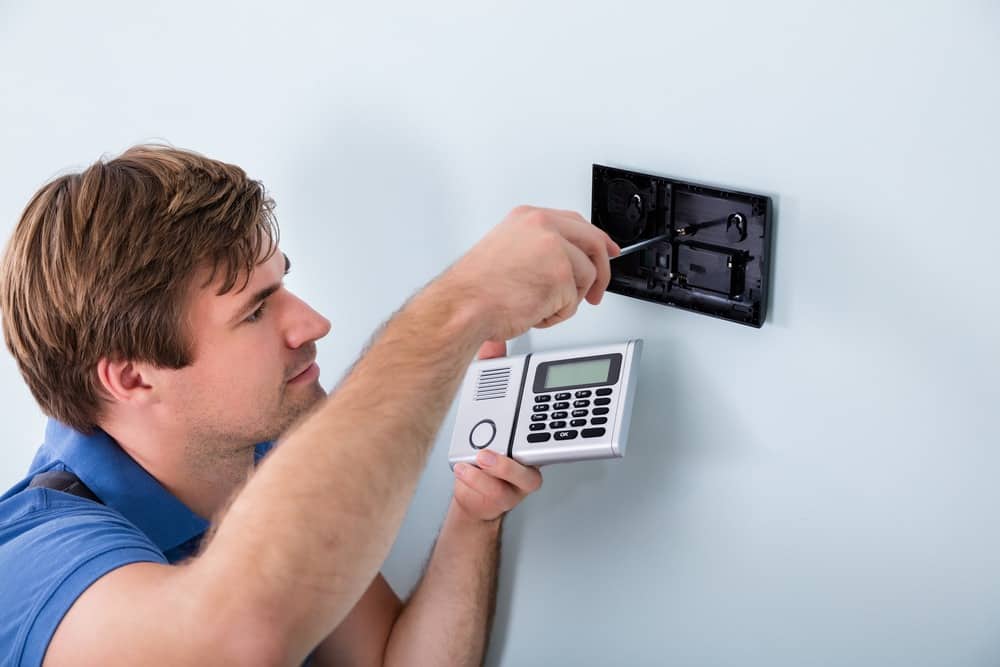 Roninn Technician installing keypad for secured entry system.