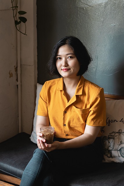 Woman sitting with a drink in hand.